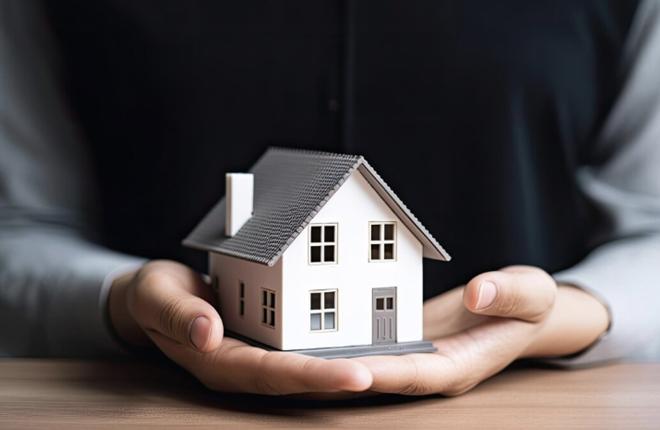 Realtor Holding a Miniature House